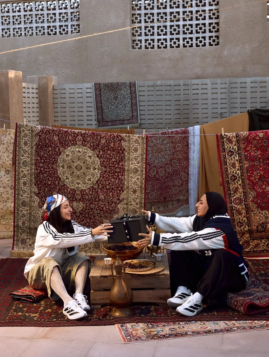 Photo shared by adidas Arabia on February 18, 2026 tagging @shahad.budebs, and @adidasuae. May be an image of one or more people, chess, headscarf, carpet and text.