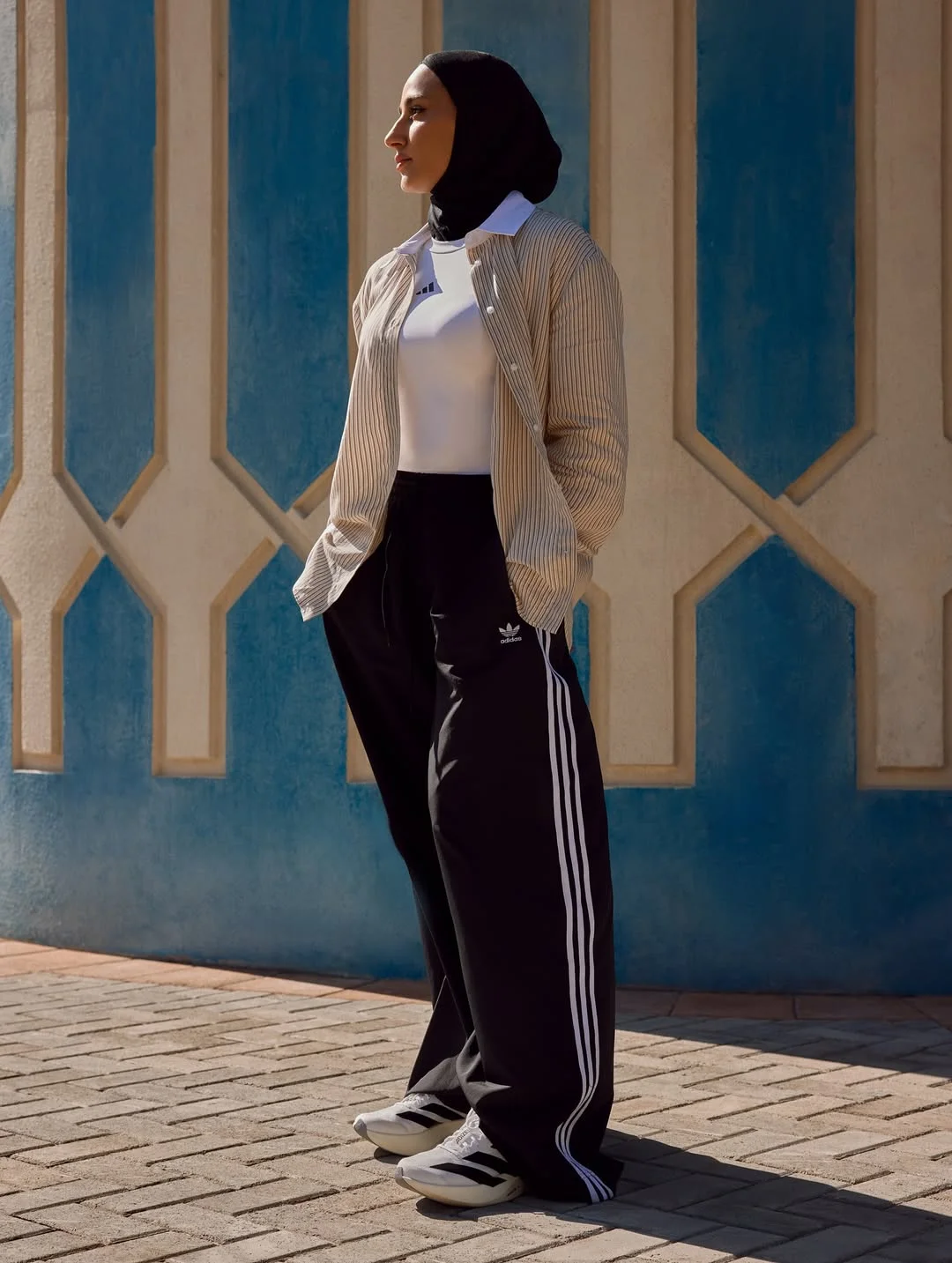 Photo shared by adidas Arabia on February 19, 2026 tagging @saharsulaimaan. May be an image of headscarf, sweatpants, sweatsuit and text.