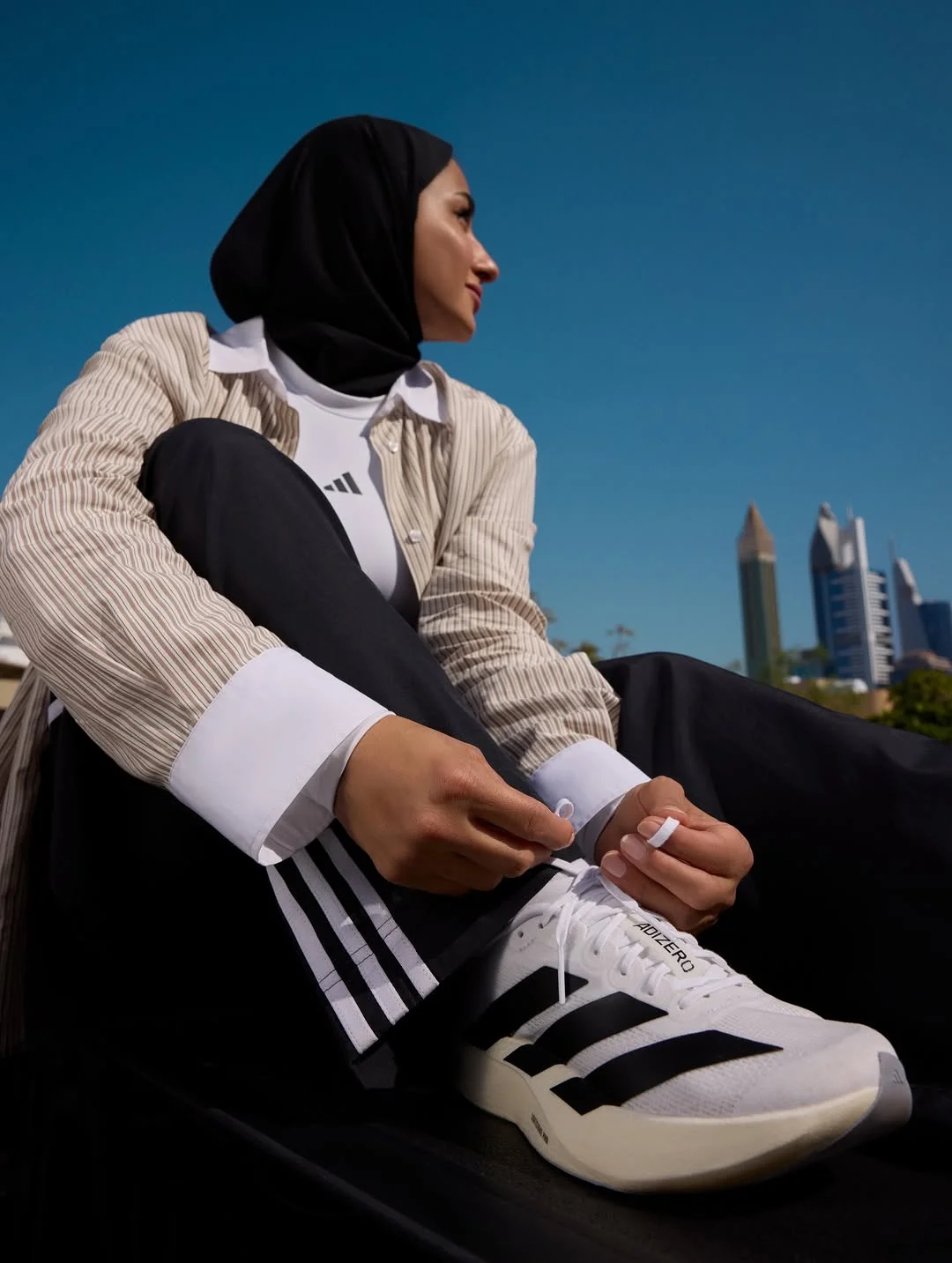 Photo by adidas Arabia on February 19, 2026. May be an image of headscarf, sneakers, sportswear and text.