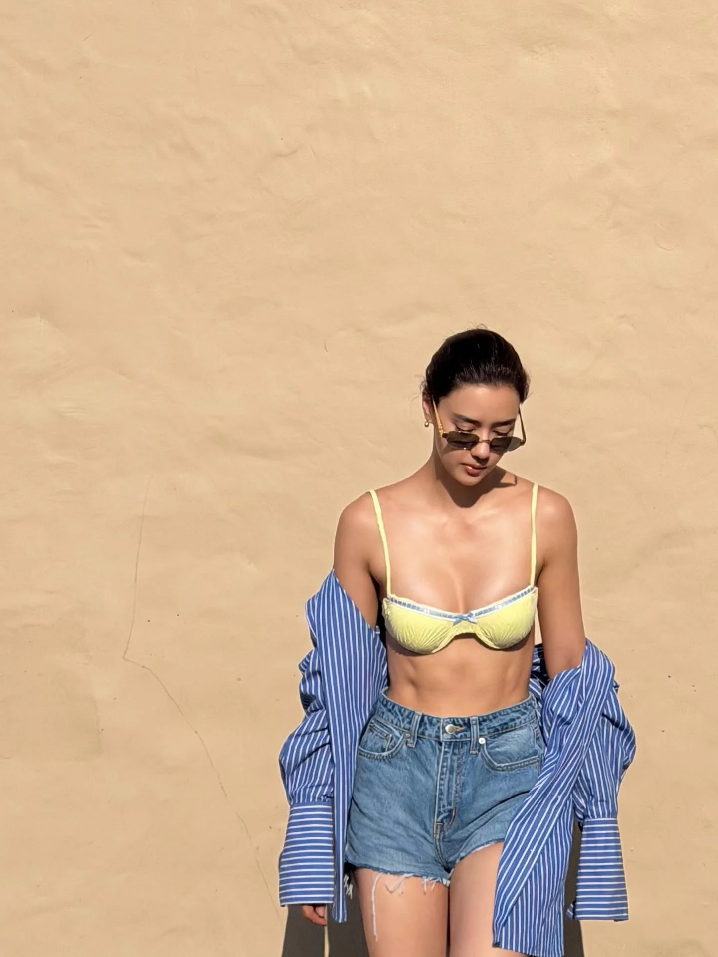 Photo by Amanda Obdam on March 21, 2026. May be an image of one or more people, eyewear, halter top, headscarf, shorts and text.