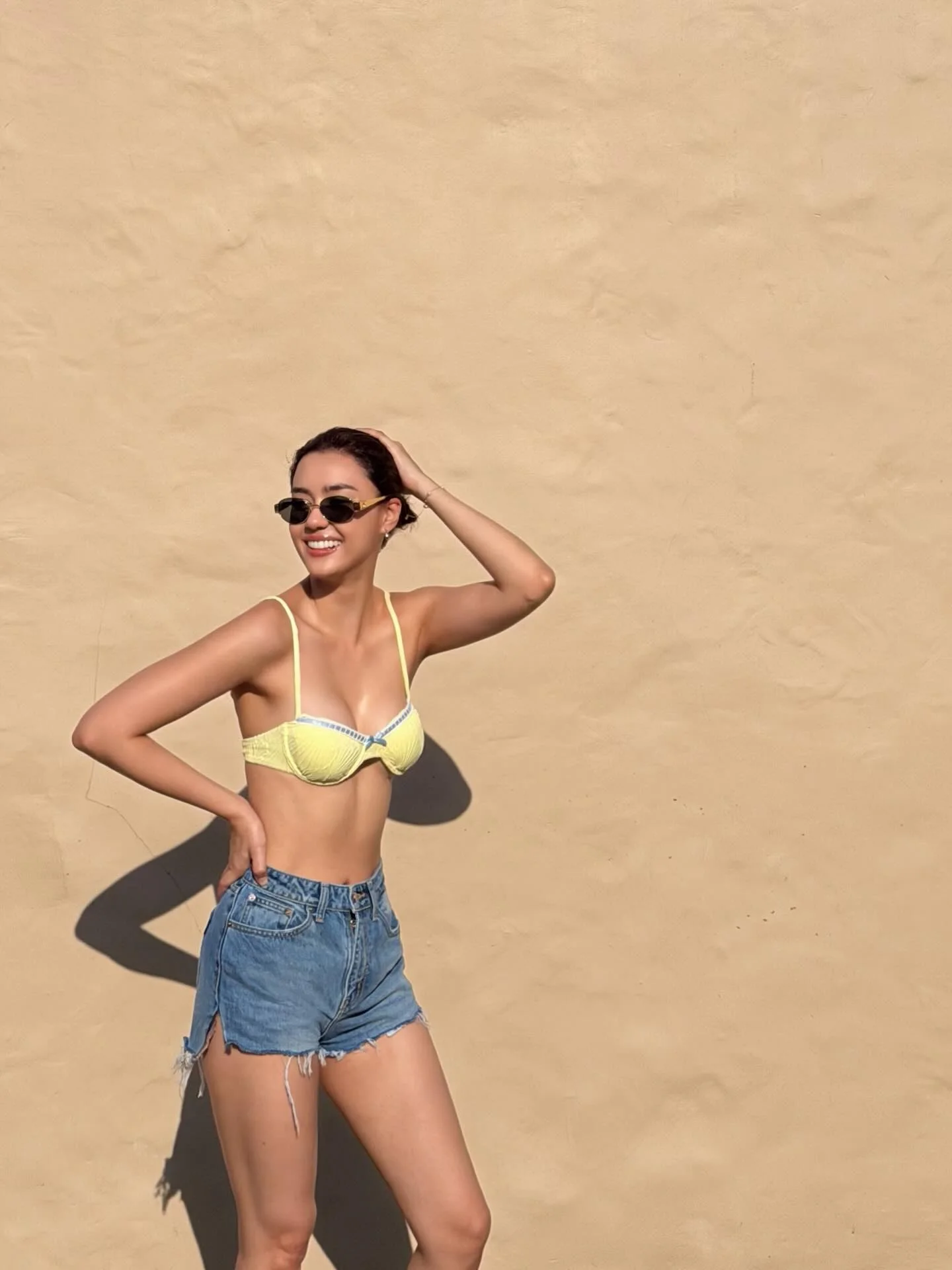 Photo by Amanda Obdam on March 21, 2026. May be an image of one or more people, activewear, eyewear, shorts, halter top and text.