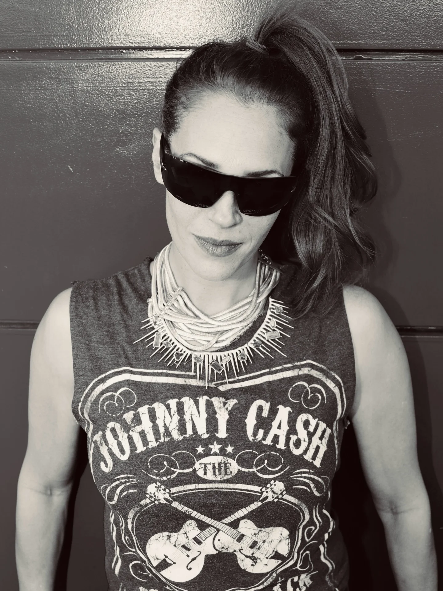 Photo by the bare magazine on March 11, 2026. May be a black-and-white image of tanktop, sunglasses, necklace and text that says 'TOHINNY CASH'.