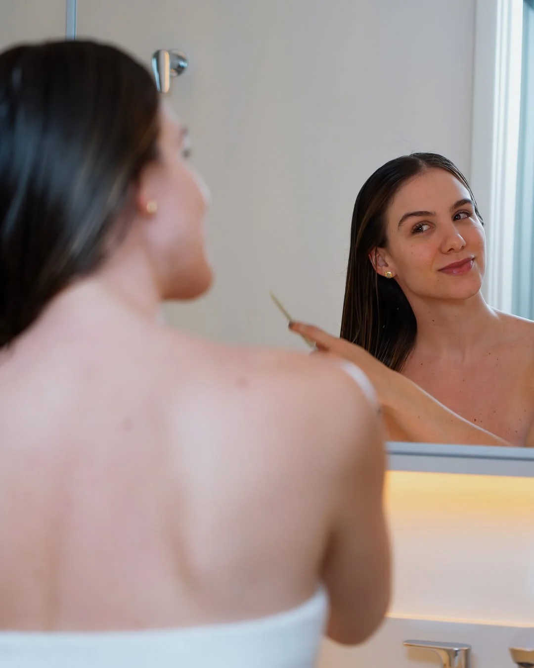 Photo by Amanda Ferrari on February 18, 2026. May be an image of one or more people, makeup, hair brush, mirror, shower and text.